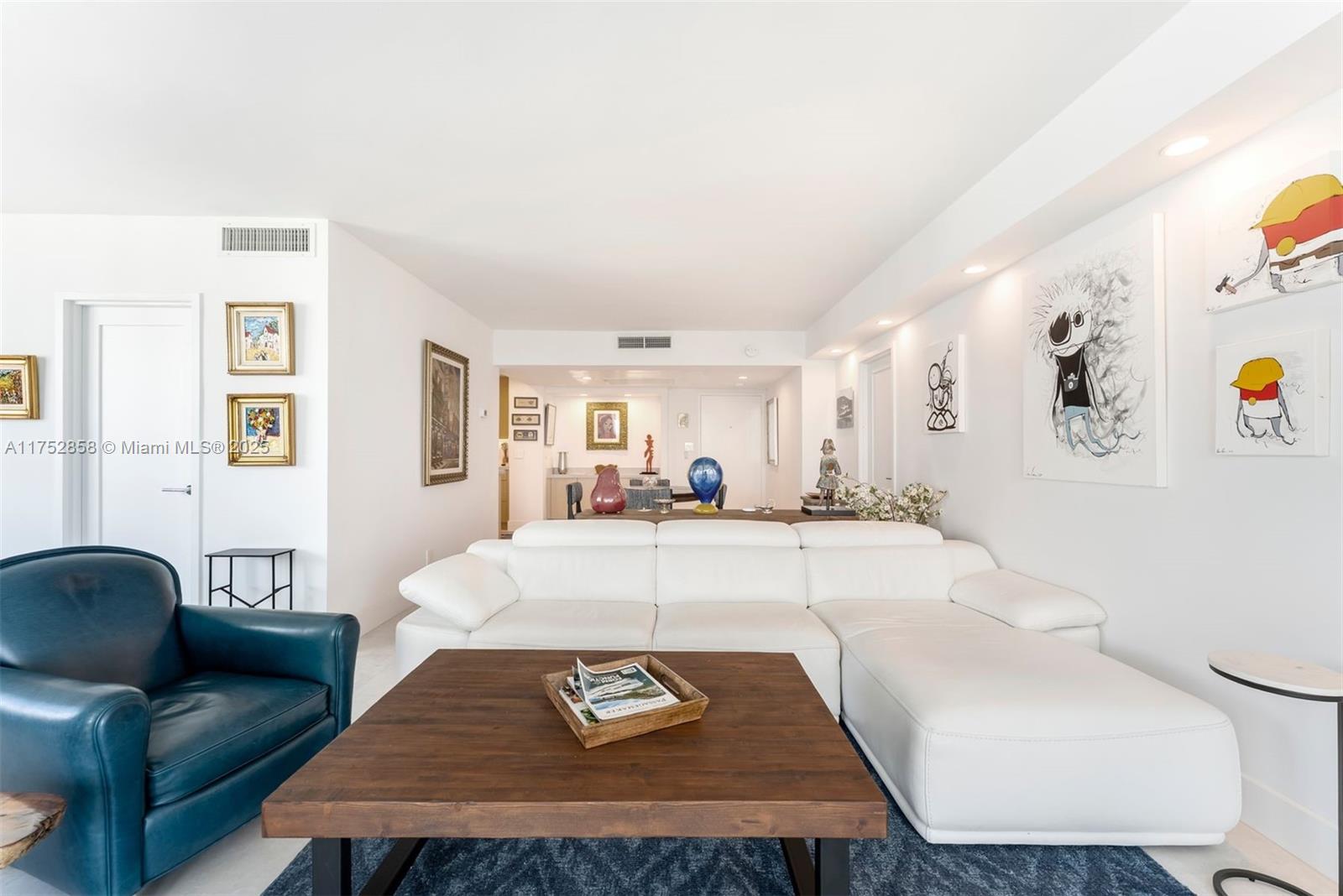 5401 Collins Avenue, Unit 1220 Miami Beach, FL 33140 - Photo 3 of 13 a living room with furniture and a table