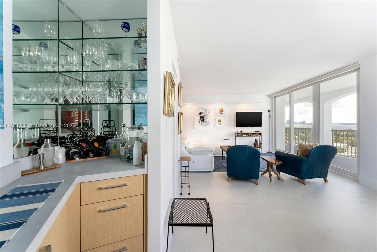 5401 Collins Avenue, Unit 1220 Miami Beach, FL 33140 - Photo 4 of 13 a living room with furniture and a flat screen tv