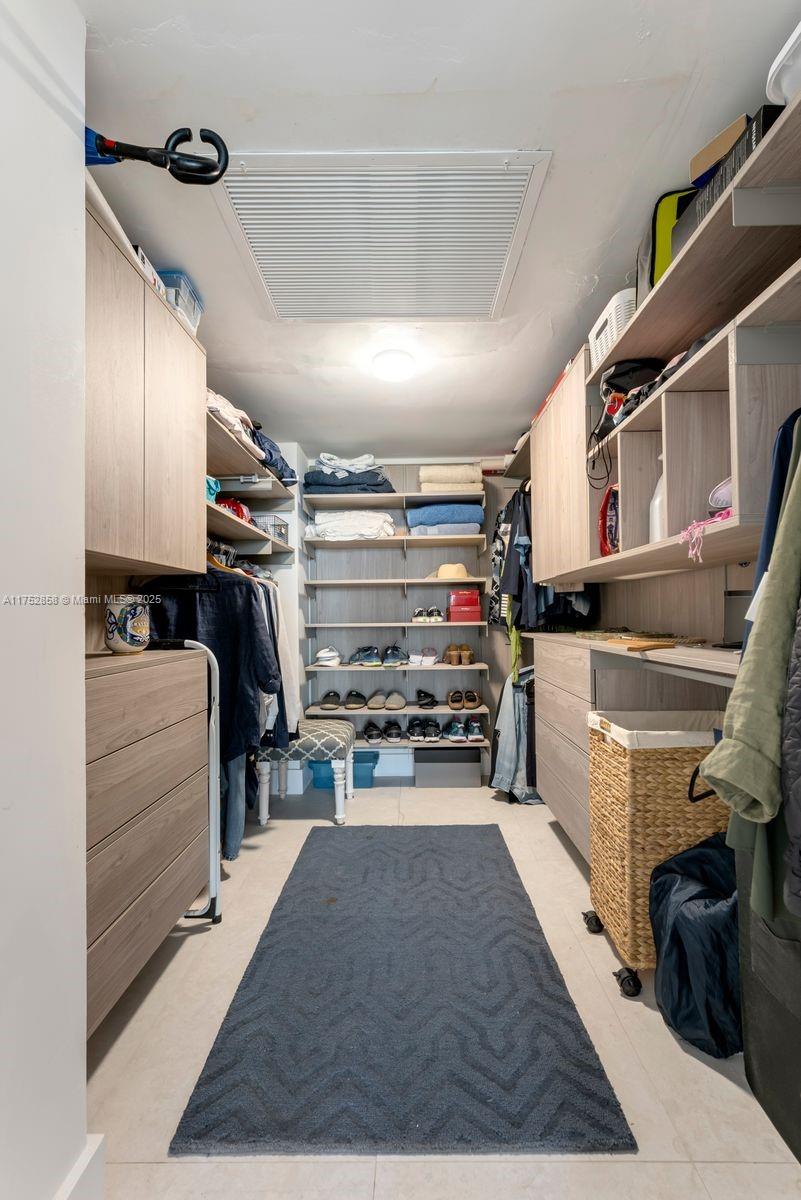 5401 Collins Avenue, Unit 1220 Miami Beach, FL 33140 - Photo 9 of 13 a kitchen with stainless steel appliances kitchen island granite countertop a stove and a refrigerator