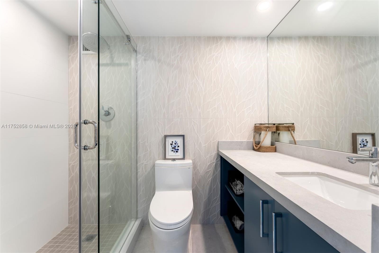 5401 Collins Avenue, Unit 1220 Miami Beach, FL 33140 - Photo 10 of 13 a spacious bathroom with a granite countertop sink a toilet and shower