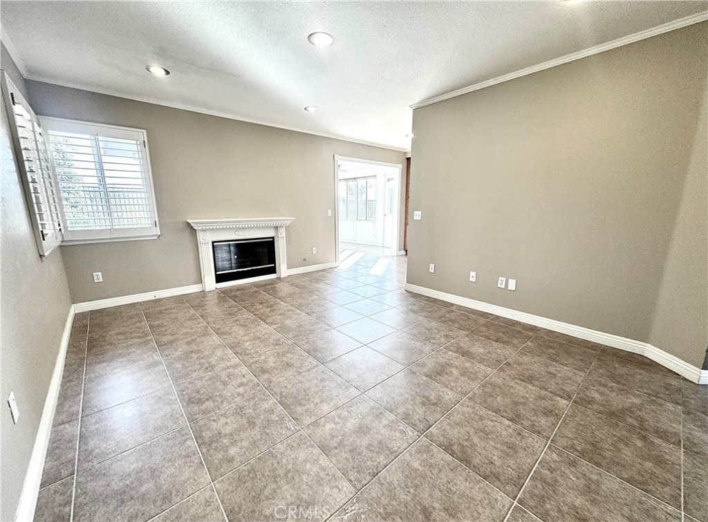 16208 Peppertree Lane La Mirada, CA 90638 - Photo 19 of 75 an empty room with windows and fireplace