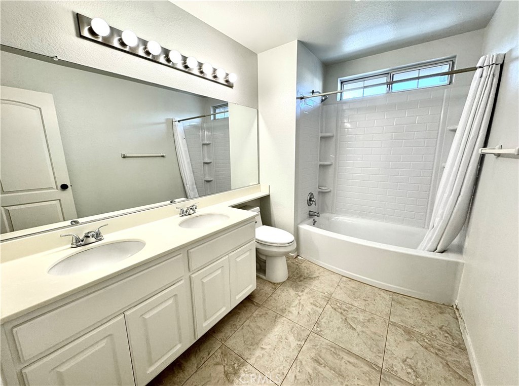 16208 Peppertree Lane La Mirada, CA 90638 - Photo 36 of 75 a bathroom with a double vanity sink mirror double and bathtub