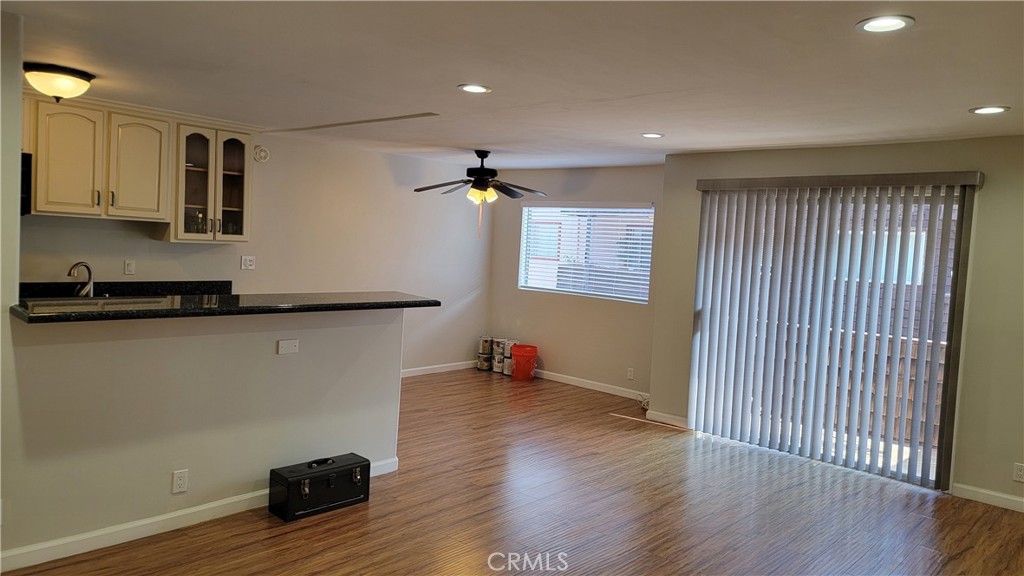5403 Newcastle Avenue, Unit 12 Encino, CA 91316 - Photo 11 of 26 an empty room with wooden floor and windows