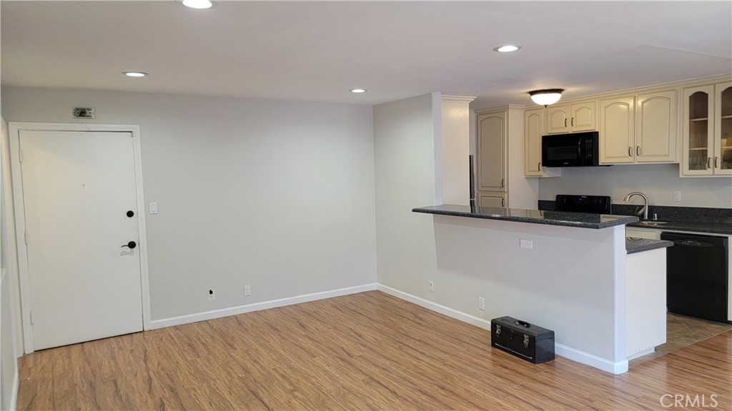 5403 Newcastle Avenue, Unit 12 Encino, CA 91316 - Photo 12 of 26 a view of a kitchen with a sink and dishwasher a refrigerator with wooden floor
