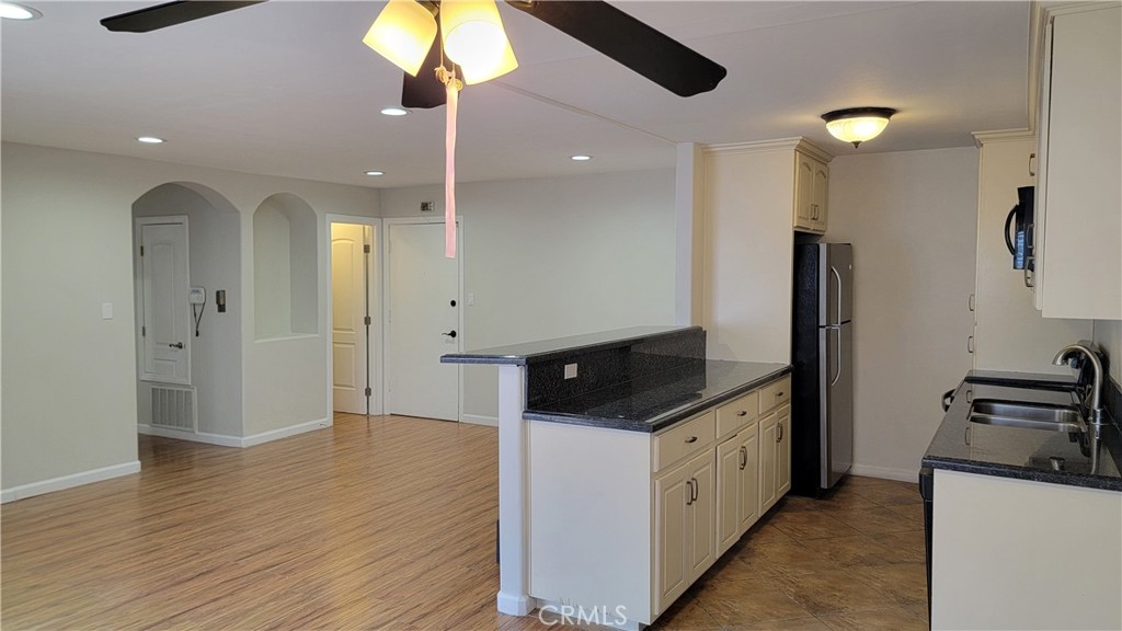 5403 Newcastle Avenue, Unit 12 Encino, CA 91316 - Photo 14 of 26 a kitchen with stainless steel appliances granite countertop a refrigerator a sink and a stove