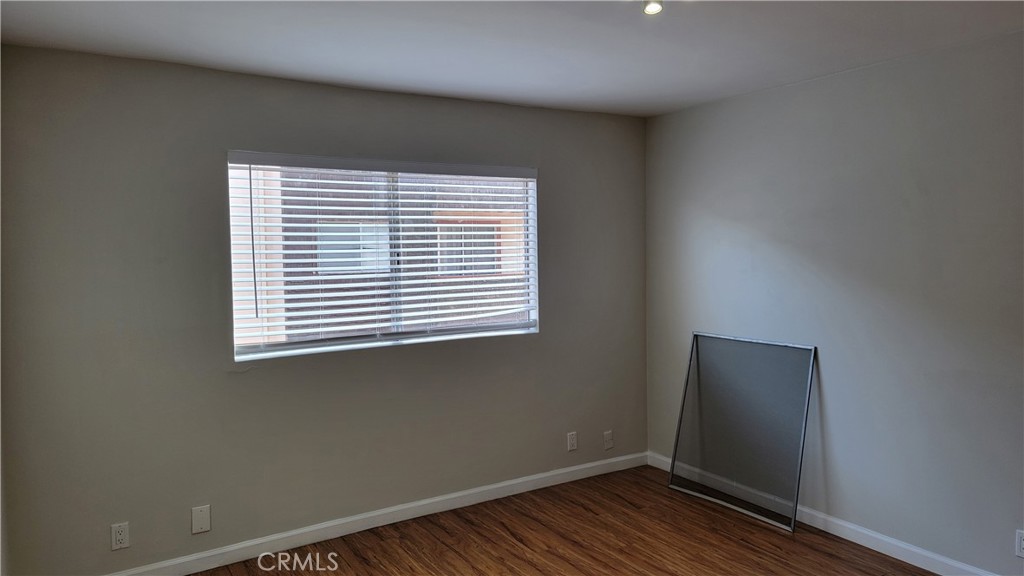 5403 Newcastle Avenue, Unit 12 Encino, CA 91316 - Photo 18 of 26 an empty room with wooden floor and windows