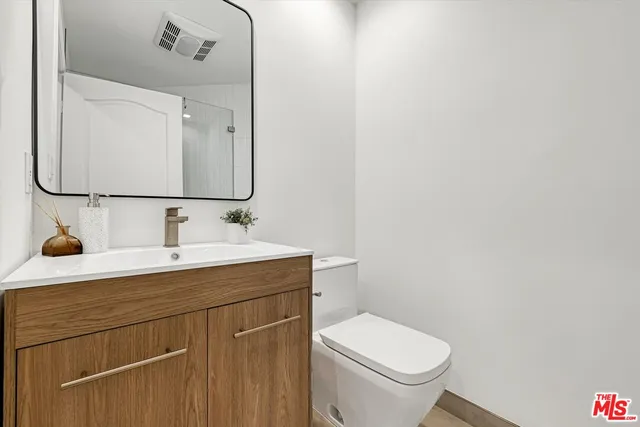 a bathroom with a sink toilet and a mirror
