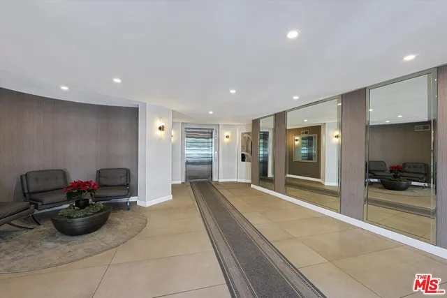 a view of a lobby with black and white furniture