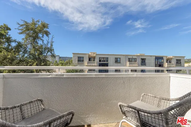 a balcony with table and chairs