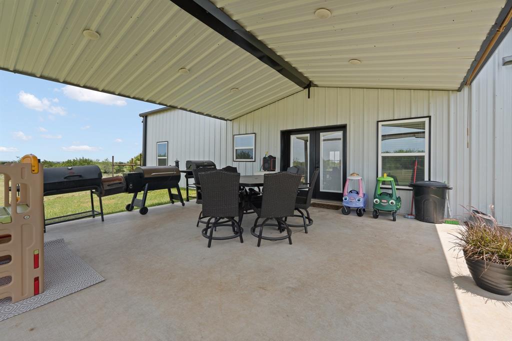 1031 Augustus Court Rio Vista, TX 76093 - Photo 21 of 30 Expansive concrete patio beneath a covered metal roof structure