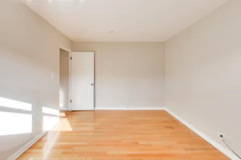 a view of room with wooden floor