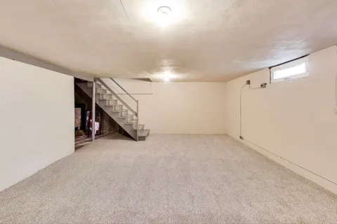 a view of an empty room with stairs