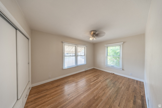 193 Locust Street Clearfield, UT 84015 - Photo 14 of 29 Spacious room featuring wood-finish flooring, light-toned walls, and multiple windows with blinds