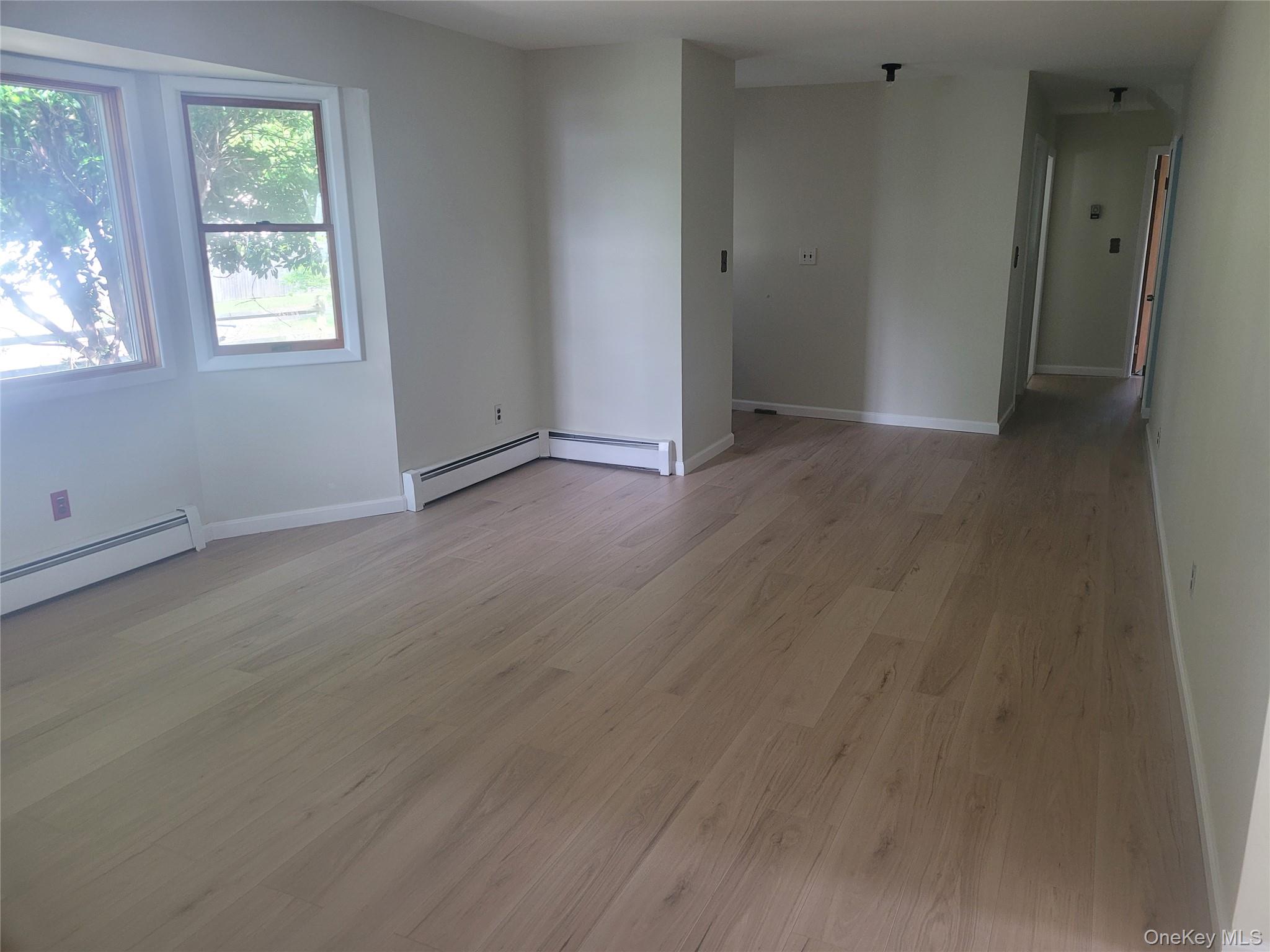 8 Cornell Road East Patchogue, NY 11772 - Photo 5 of 18 an empty room with windows
