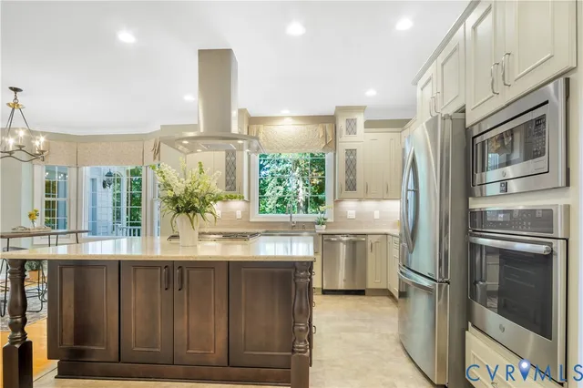 a kitchen with kitchen island granite countertop a stove and a sink
