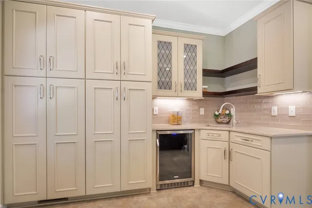 a kitchen with white cabinets and sink