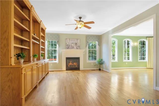 a view of an empty room with a fireplace and a window