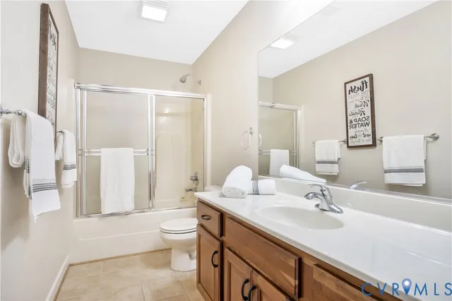 a bathroom with a sink a toilet and a large mirror