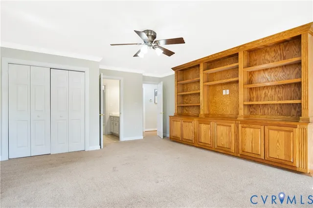 a view of an empty room with a ceiling fan