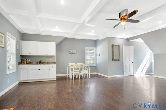 a kitchen with granite countertop stainless steel appliances refrigerator dining table and chairs