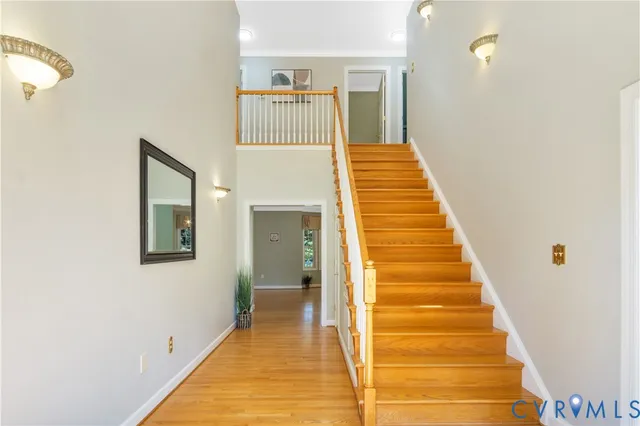 a view of a hallway with wooden floor and entryway