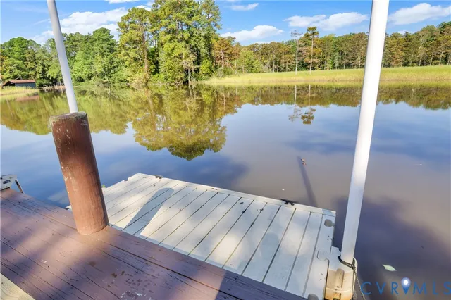 a view of a balcony with lake view and wooden floor