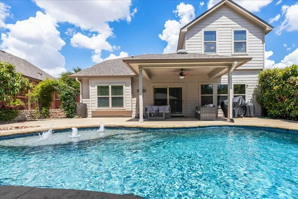 a view of a house with pool and chairs