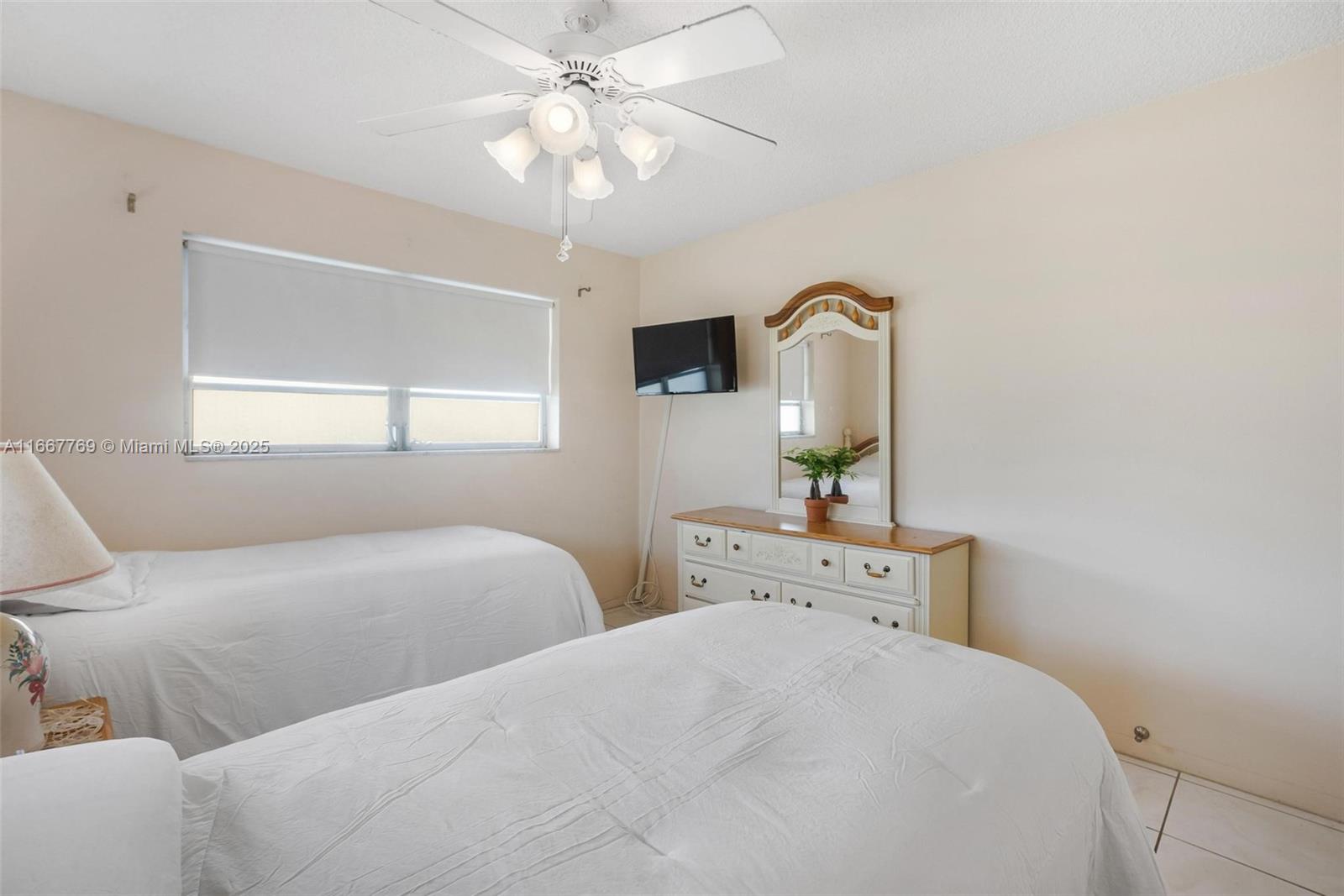 5300 Washington Street, Unit C111 Hollywood, FL 33021 - Photo 16 of 40 a bedroom with a bed and a chandelier