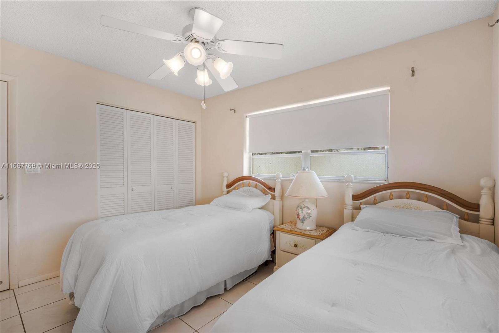 5300 Washington Street, Unit C111 Hollywood, FL 33021 - Photo 17 of 40 a bedroom with a bed and a chandelier