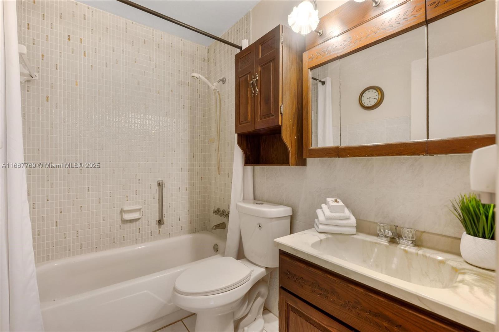 5300 Washington Street, Unit C111 Hollywood, FL 33021 - Photo 21 of 40 a bathroom with a sink a toilet and shower