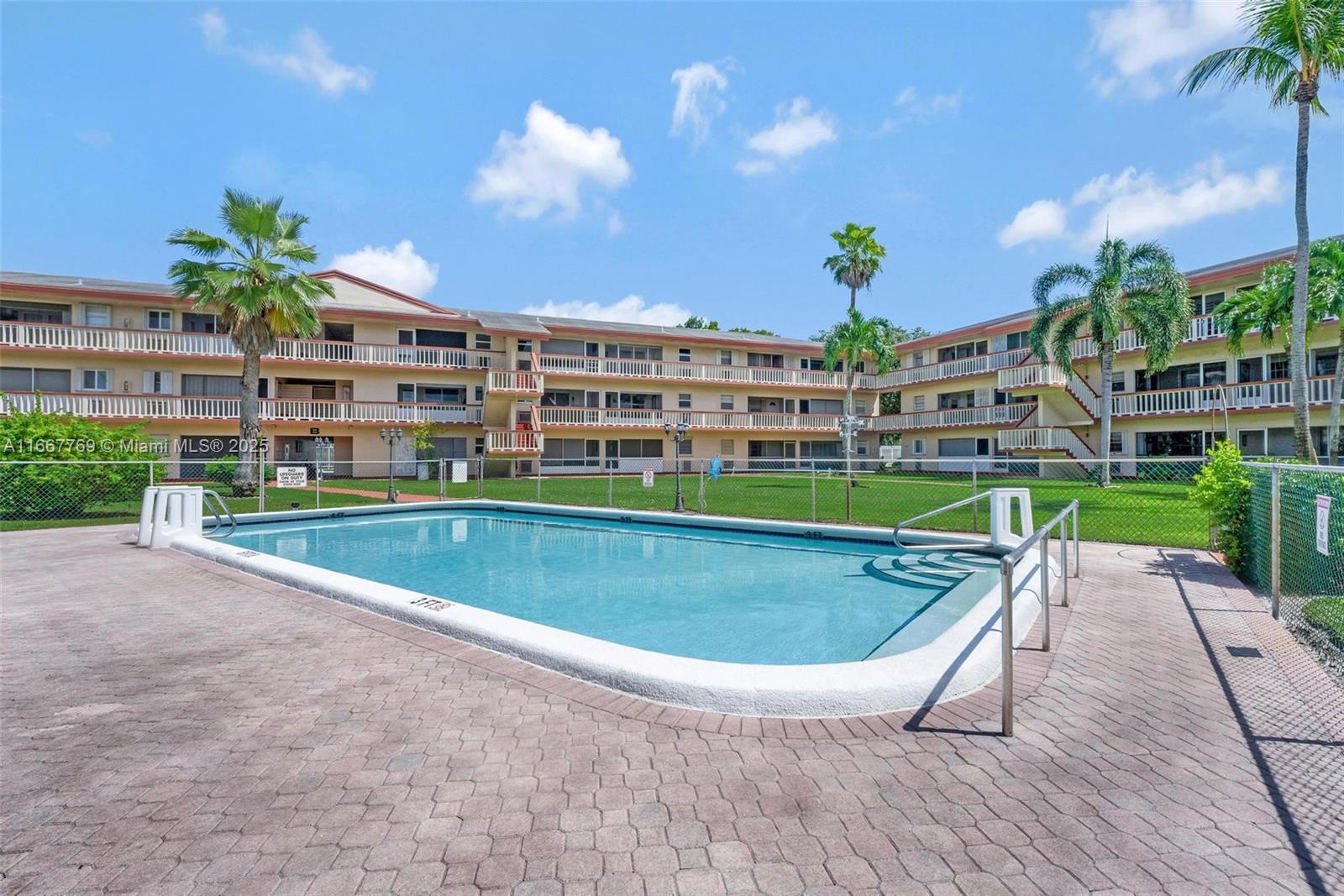 5300 Washington Street, Unit C111 Hollywood, FL 33021 - Photo 26 of 40 a view of a swimming pool with a patio and plants