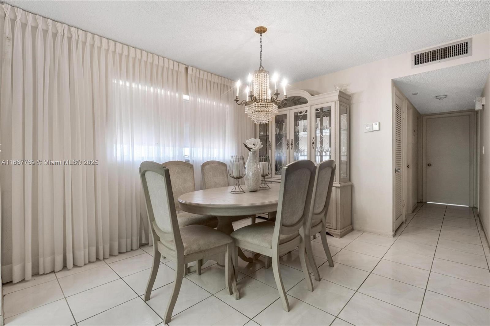 5300 Washington Street, Unit C111 Hollywood, FL 33021 - Photo 10 of 40 a view of a dining room with furniture and chandelier