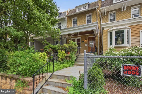 a view of a house with potted plants