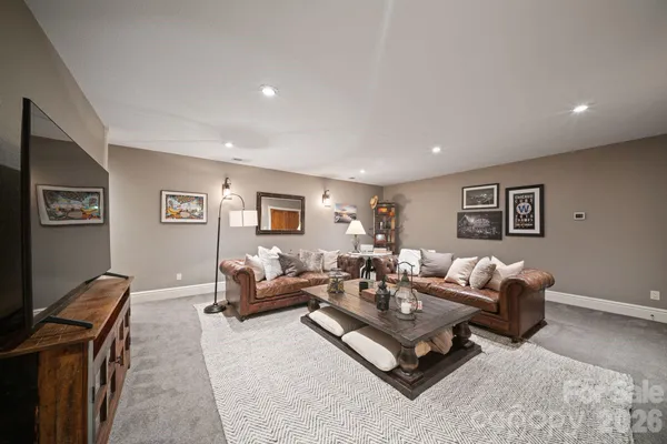 a living room with furniture and a chandelier