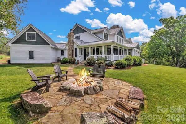 a aerial view of a house with a yard sitting space and mountain view