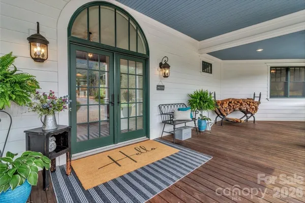 a hallway with sliding door and a chandelier