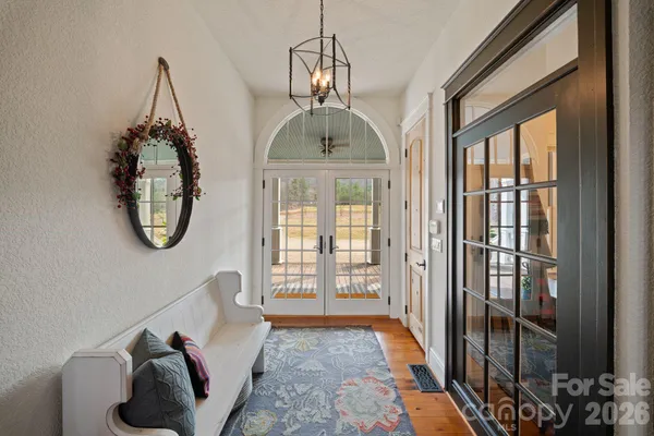 a living room with fireplace furniture and a large window
