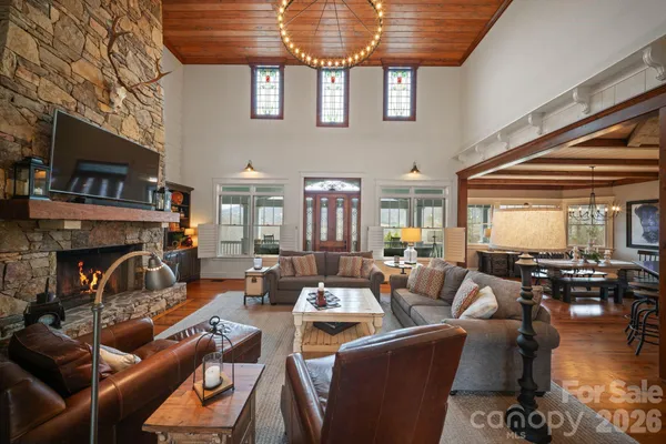 a living room with furniture large window and fireplace