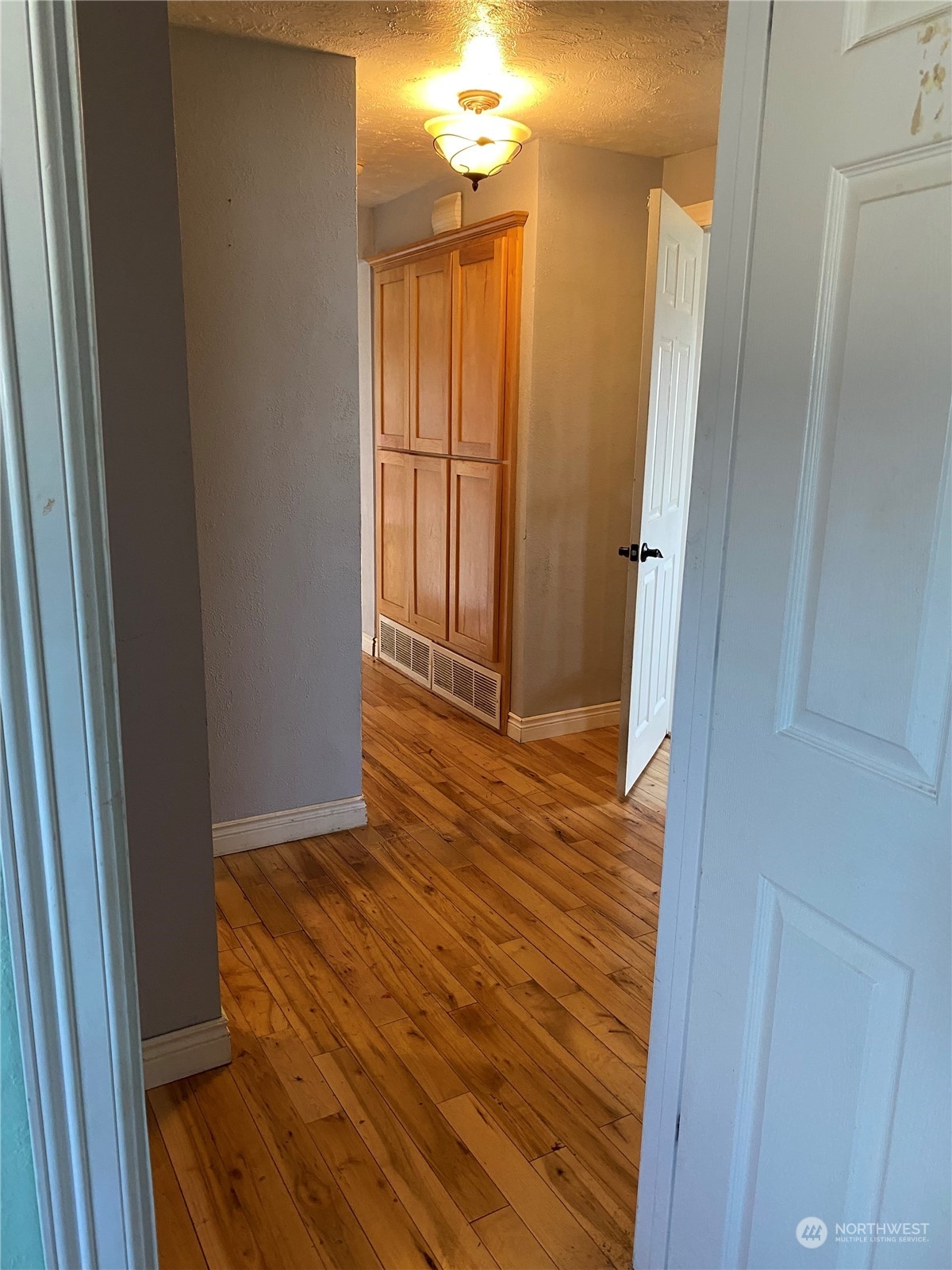 4008 North Marguerite Road Spokane, WA 99212 - Photo 14 of 40 a view of a hallway with wooden floor