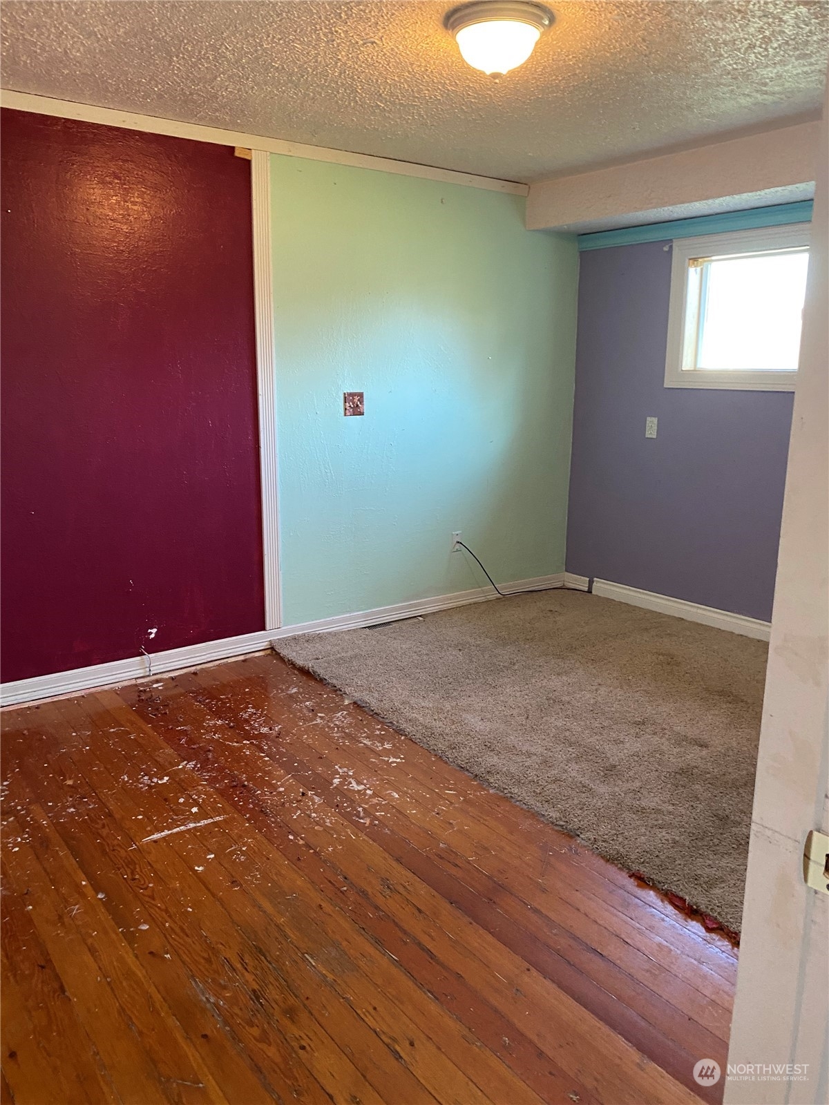 4008 North Marguerite Road Spokane, WA 99212 - Photo 15 of 40 an empty room with wooden floor and windows