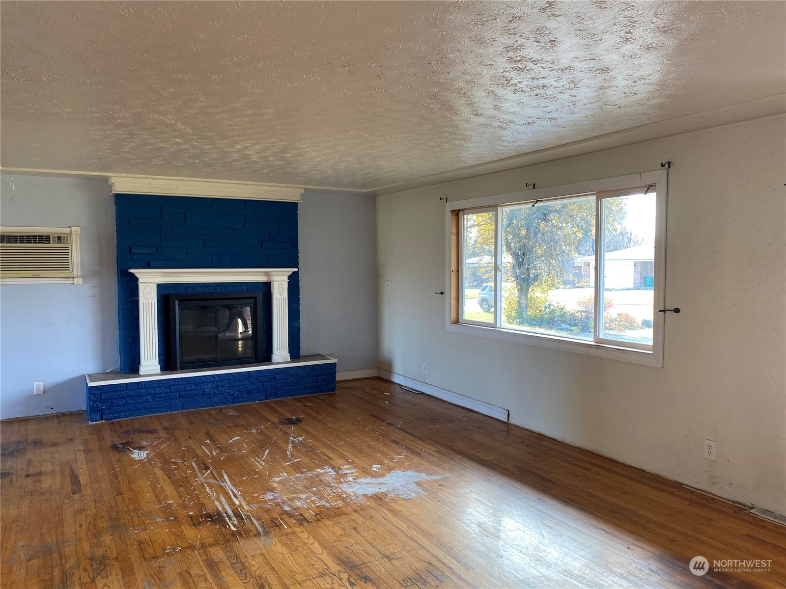 4008 North Marguerite Road Spokane, WA 99212 - Photo 3 of 40 a view of an empty room with a fireplace and a window