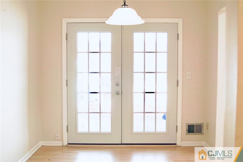 134 Redpine Loop Old Bridge, NJ 08857 - Photo 4 of 12 a window in an empty room with wooden floor