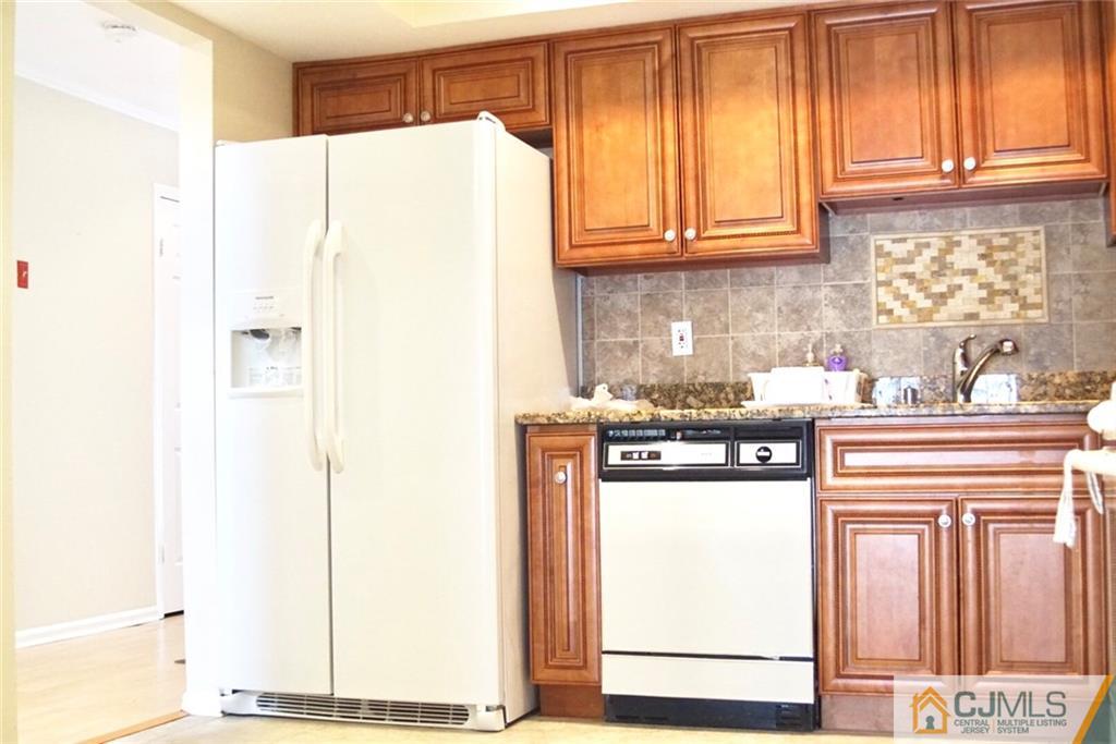 134 Redpine Loop Old Bridge, NJ 08857 - Photo 5 of 12 a kitchen with stainless steel appliances granite countertop a refrigerator and a stove