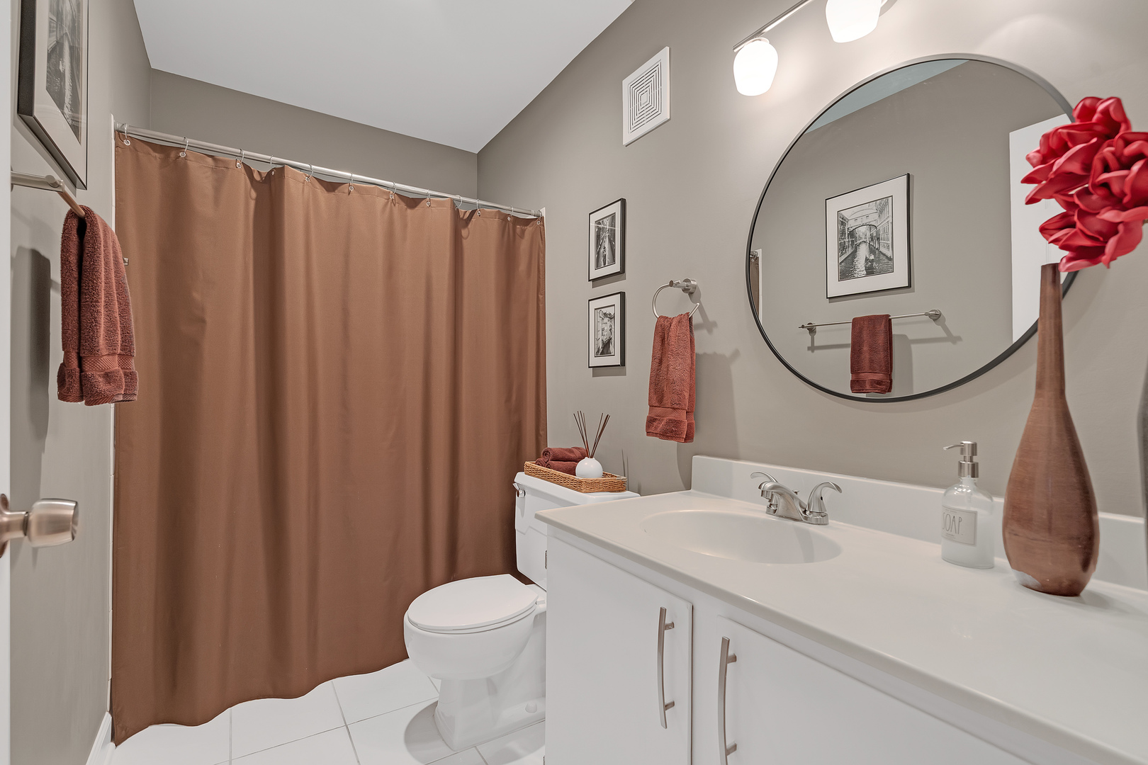 727 Killarney Court, Unit 2D Schaumburg, IL 60193 - Photo 12 of 21 a bathroom with a sink vanity mirror and toilet