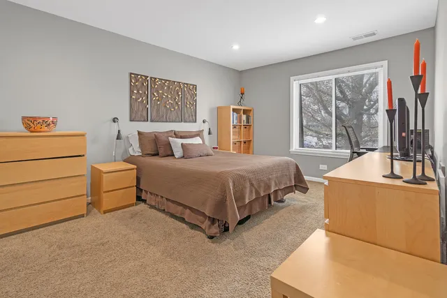 a bedroom with a bed and a dresser