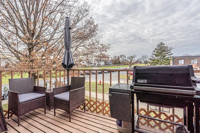 a view of balcony with wooden floor and seating space