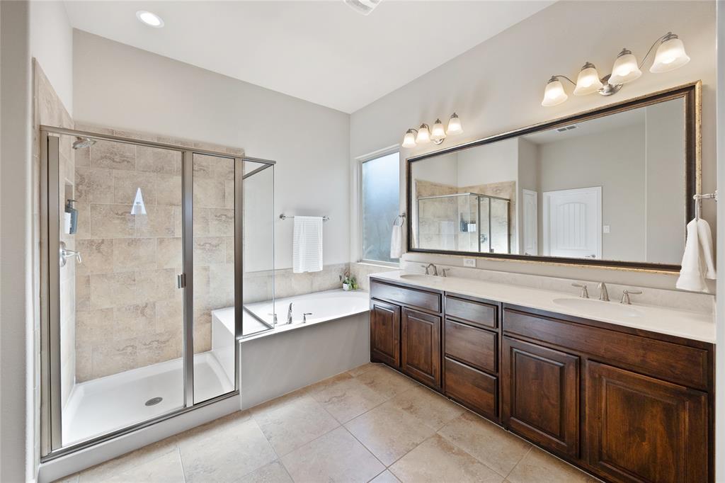216 Equestrian Road Hickory Creek, TX 75065 - Photo 14 of 26 a bathroom with a bathtub shower sink double vanity and mirror
