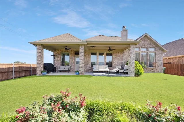 a view of a house with swimming pool and sitting area