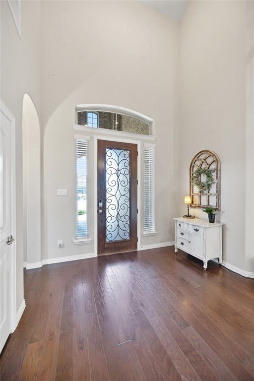 216 Equestrian Road Hickory Creek, TX 75065 - Photo 2 of 26 a view of an empty room with window and wooden floor