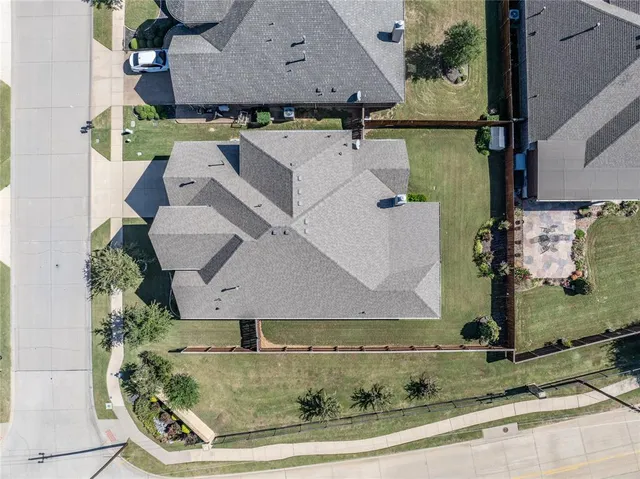 an aerial view of a house with a yard